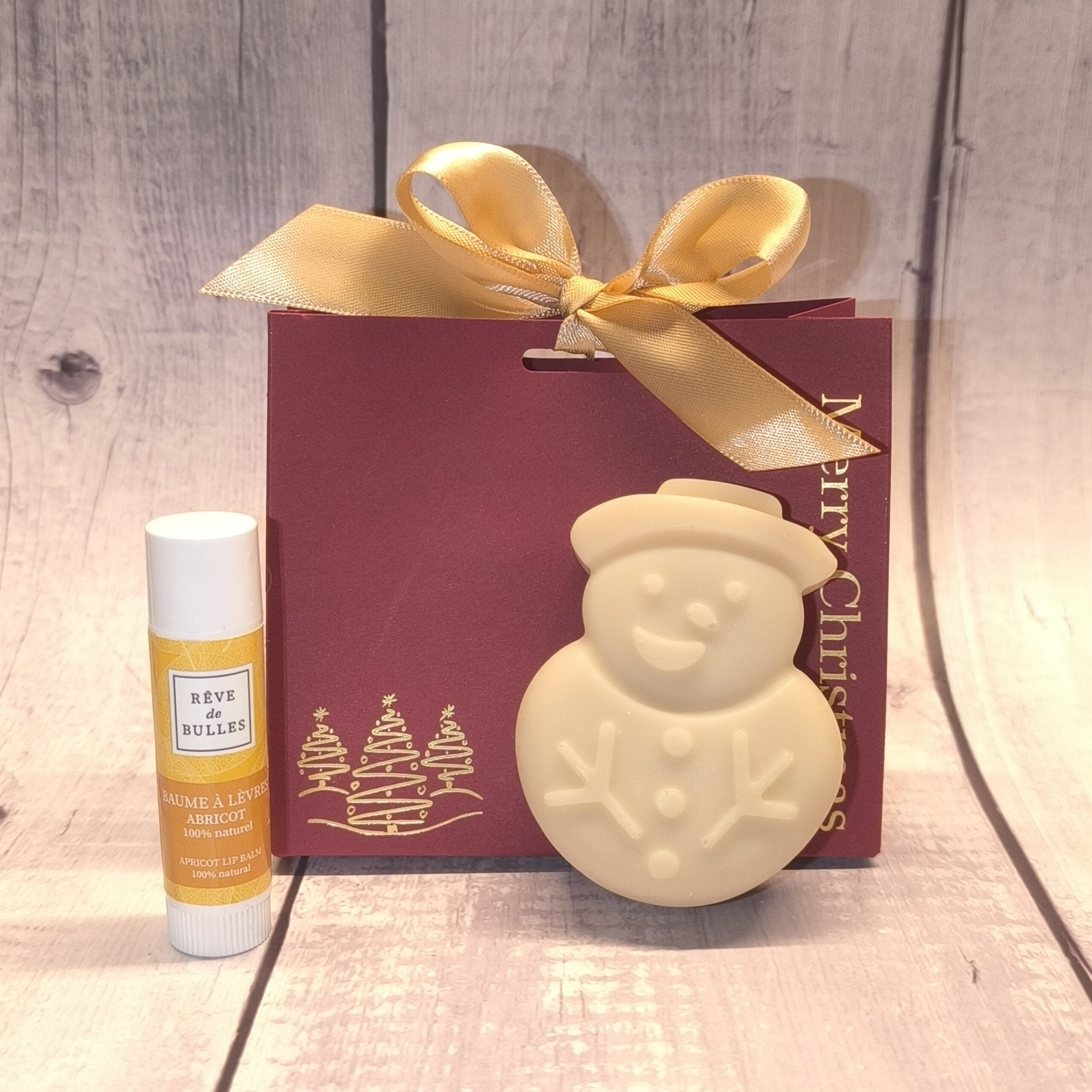 Pochette de Noël savon bonhomme de neige et stick à lèvres abricot